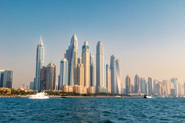 A scenic skyline of Dubai's high-rise real estate buildings along the waterfront.