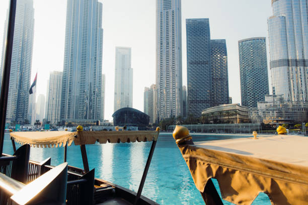 View of modern skyscrapers in Dubai from a boat, highlighting the allure of the real estate market.